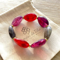 Bracelet élastique en perles acrylique et acier inoxydable modèle Joia