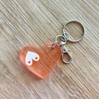 Porte-clés bijou de sac avec breloque fleur en résine modèle Espoir Octobre rose